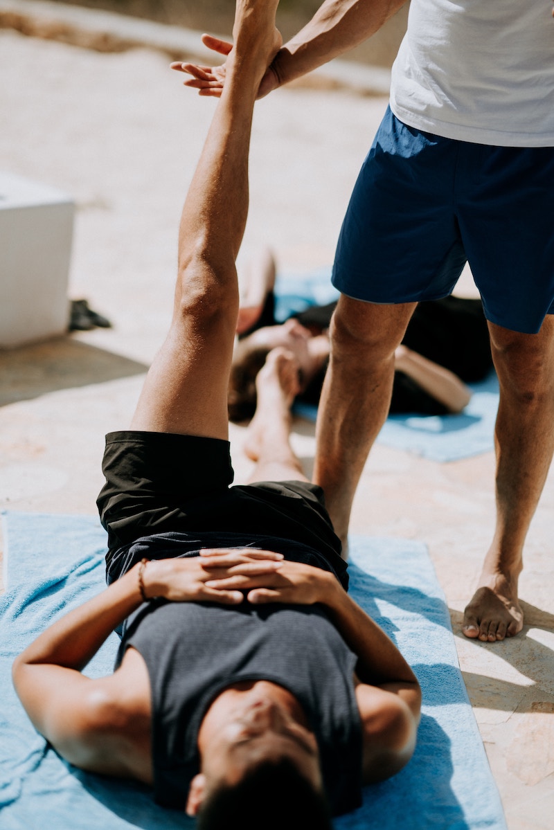 Yoga adjustment in Supta padangusthasana